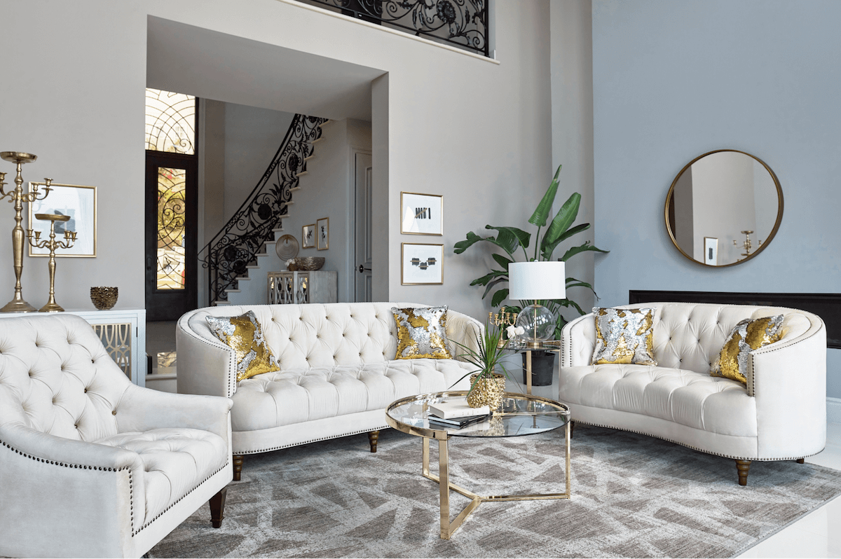 Modern living room with white sofa, armchair, and decorative elements.