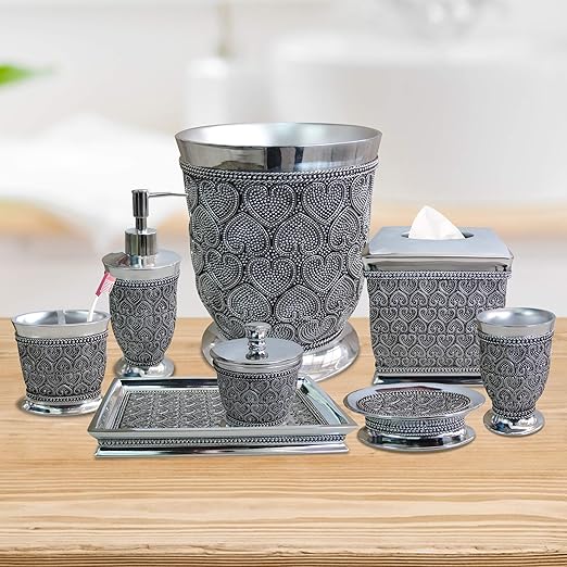 Silver and black patterned bathroom accessory set on a wooden surface